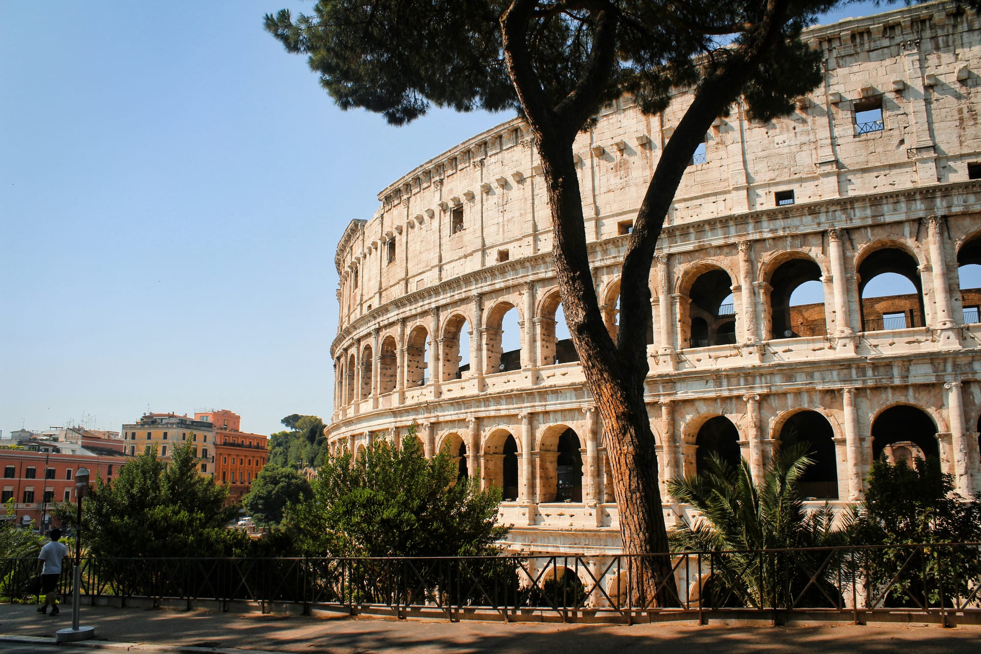 The ancient Roman Colosseum is illuminated by the golden light of the sun as it rises, showcasing its grandeur and history.