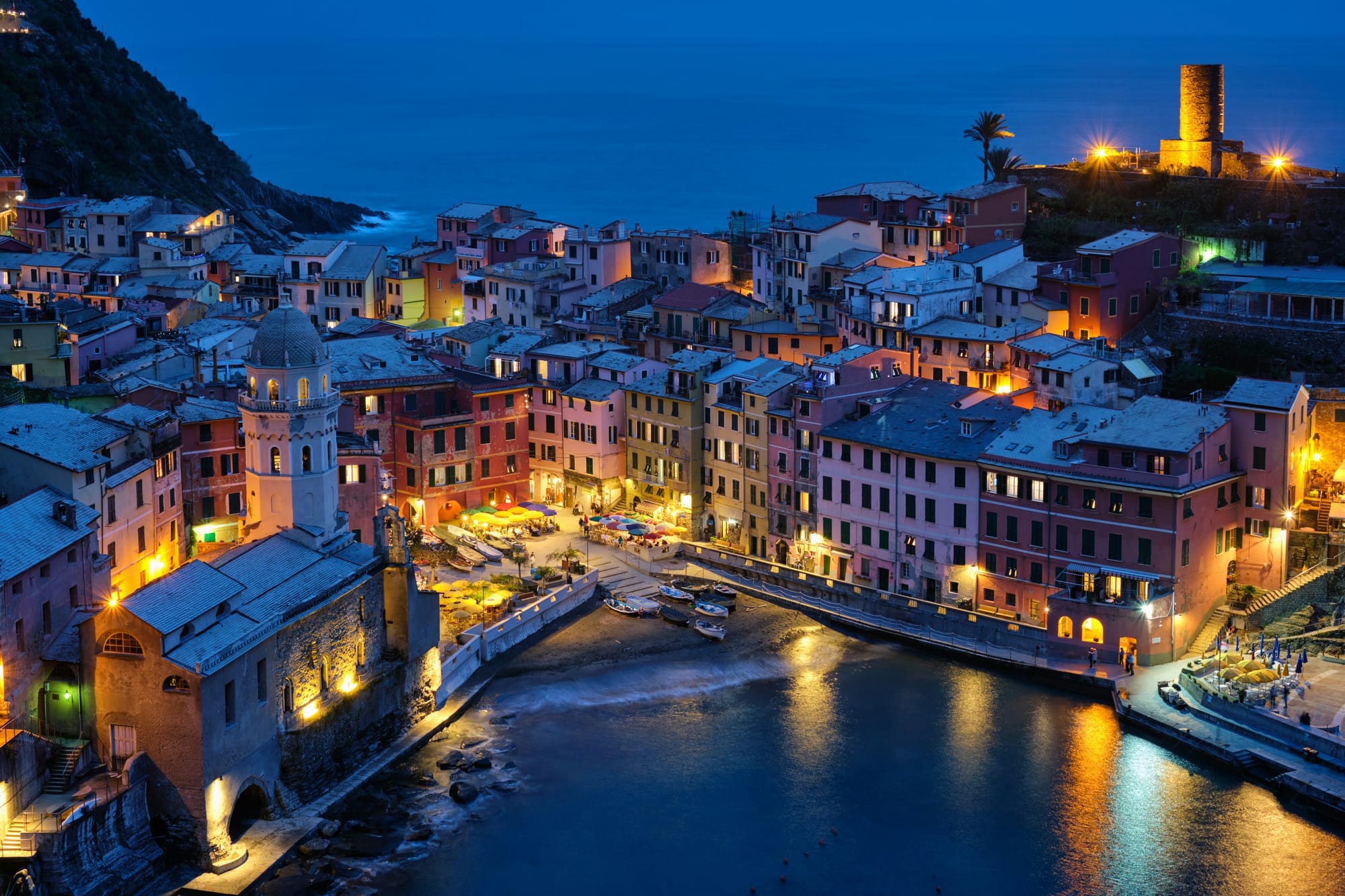 A typical fishing village in Italy is bathed in the blue hour.