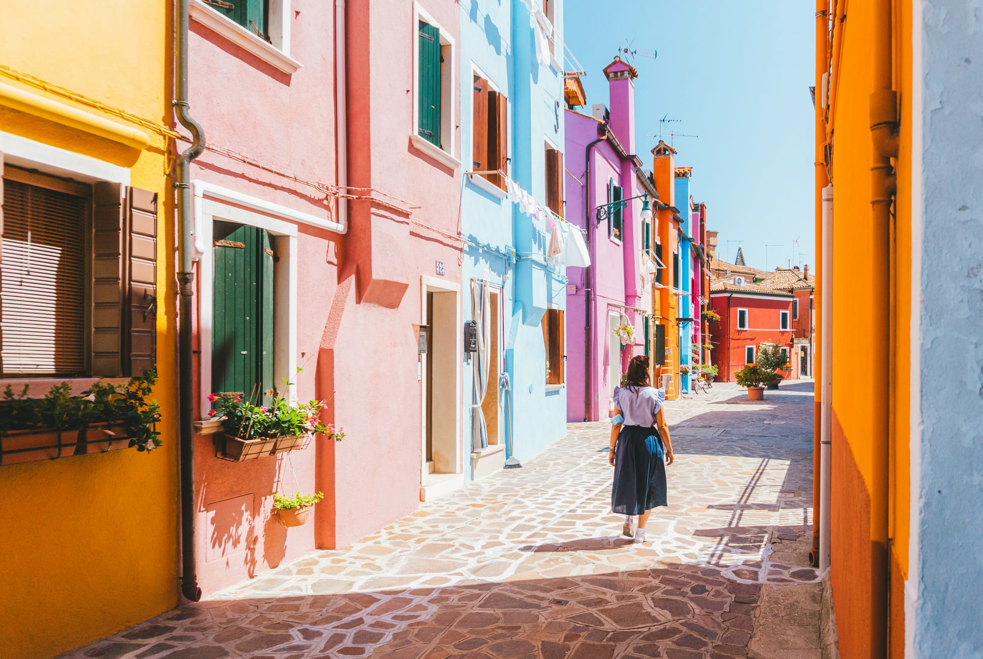 Experience the magic of wandering among the colorful houses in Burano, Italy.